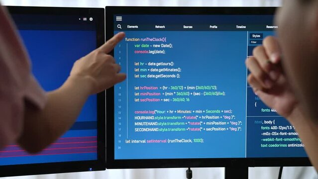 Slow motion back end software developer engineer for computer programming working together on debugging writing computing code, solving complex algorithms display on monitor in office. Burgeoning