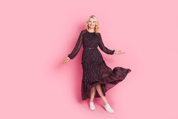 Full size photo of pretty aged lady dance throw dress isolated on pink color background