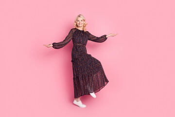 Full size photo of pretty aged lady empty space dance wear dress isolated on pink color background