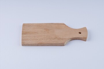 Wooden cutting board on white background with studio lighting