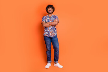 Full length photo of handsome young man crossed hands confident dressed stylish colorful garment isolated on orange color background