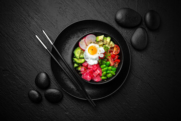 Tuna Poke bowl composition on black background. The Art of Japanese Cuisine. Food photography for menu and sushi bar decoration