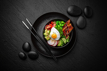 Smoked Eel Poke bowl composition on black background. The Art of Japanese Cuisine. Food photography for menu and sushi bar decoration