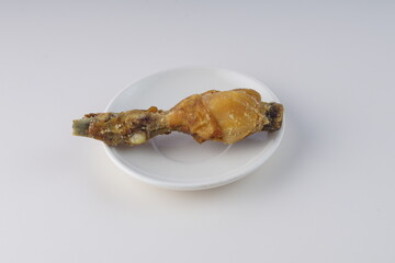 pieces of fried chicken on a white plate on a white table with studio lighting