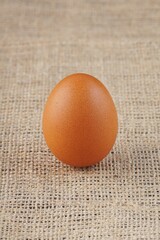 chicken eggs in a wooden bowl on a table with studio lighting