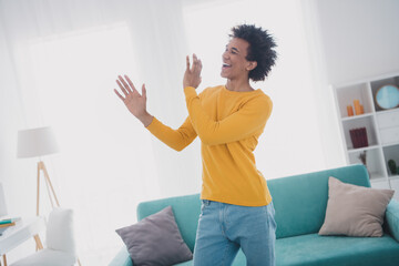 Photo of nice young man have fun dance wear yellow pullover white interior apartment indoors