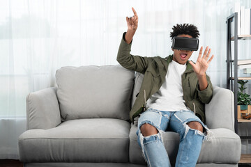 Surprised African American looking VR enjoy watching by touching the air in fantastic 3D cartoon...