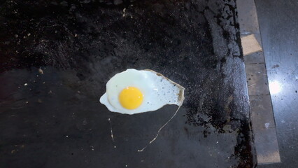 Delicious Fried Egg Cooking on Hot Griddle Overhead View