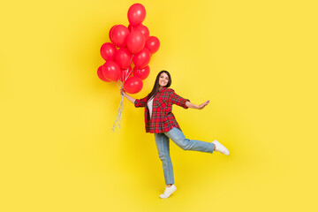 Full length photo of charming girly lady wear plaid shirt holding baloons bouquet empty space...