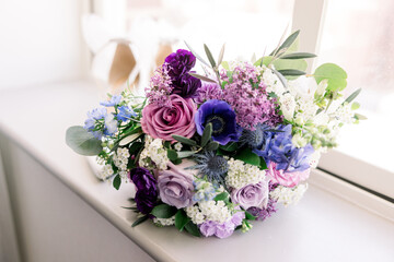 A beautiful purple and pink wedding bouquet, perfect for a spring wedding