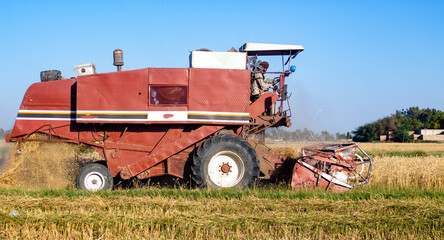 a wheat cutting machine swiftly harvesting a field of wheat