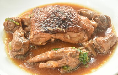 steamed chicken thigh and feet with garlic black pepper gravy sauce stew on plate