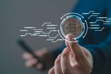 Businessman holding smartphone and gold bitcoin, trader investor analyst buying cryptocurrency tokens analyzing stock market data investment risks using online trading mobile app concept.