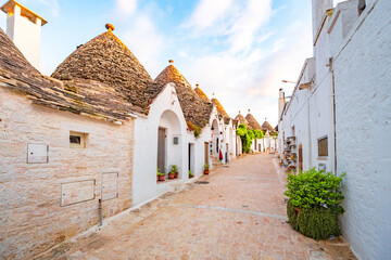Trulli of Alberobello, Puglia, Italy. town of Alberobello with trulli houses among green plants and flowers