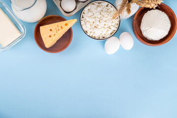 Various dairy organic foods background containing cheese, cottage cheese, eggs, milk, sour cream,...