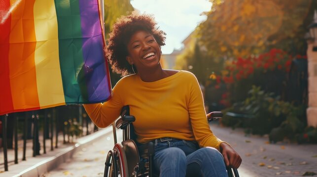 happy african american disabled lesbian woman in wheelchair with rainbow pride flag diversity and inclusion