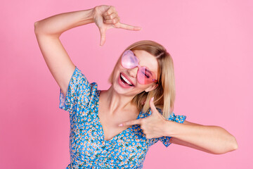 Photo of adorable pretty girl dressed blue top dark eyewear showing arms photo gesture isolated...