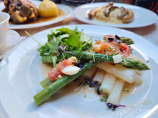 Green and white asparagus salad on the plate. Tasty and healthy vegetables dish. spot focus