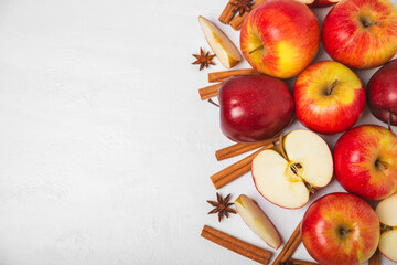 Apples with cinnamon on a textured wooden background. Fragrant red spiced apples with cinnamon...