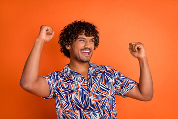Photo portrait of handsome young man winning raise fists dressed stylish colorful garment isolated...