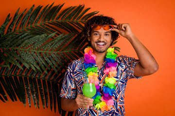 Photo of attractive young man drink cocktail enjoy summer palm leaves dressed stylish colorful...