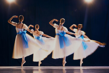 Dancers' rapid movements create a beautiful blur, giving impression of ethereal, ghostly figures on...