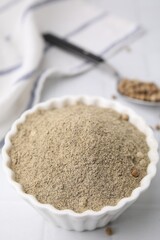 Ground pepper on white tiled table, closeup