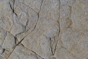 Stone texture worn by the wind and the sea of ​​the coast located on a wild beach.