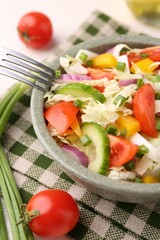 Tasty salad with Chinese cabbage in bowl on table, closeup