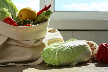 Fresh Chinese cabbage and other products on wooden table indoors