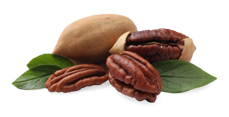 Many tasty pecan nuts with green leaves isolated on white