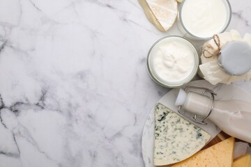 Different fresh dairy products on white marble table, top view. Space for text