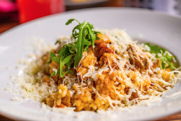 Risotto with chicken meat, grated cheese and rucola leaf.