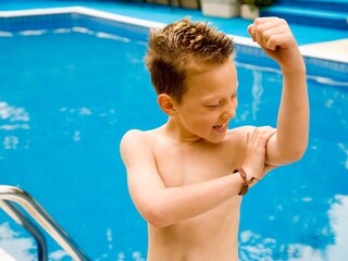 Boy Examines His Bicep