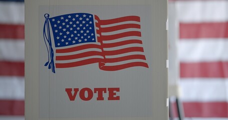 Close up, side of voting booths, with clear view of vote wording and flag at polling station in...