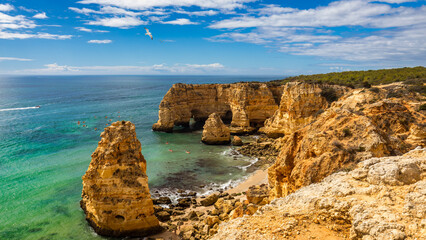 Fototapeta premium Praia da Marinha, beautiful beach Marinha in Algarve, Portugal. Navy Beach (Praia da Marinha) with flying seagulls over the beach, located on the Atlantic coast in Lagoa Municipality, Algarve.