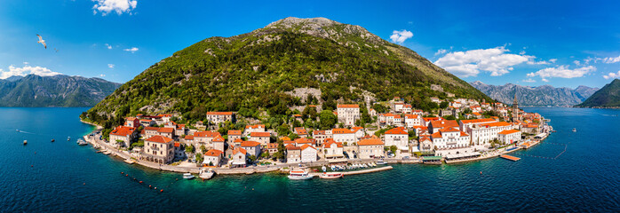 View of the historic town of Perast at famous Bay of Kotor on a beautiful sunny day with blue sky and clouds in summer, Montenegro. Historic city of Perast at Bay of Kotor in summer, Montenegro.