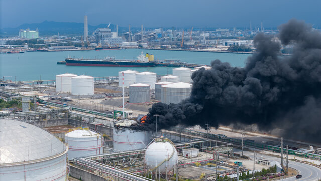 Huge fire exploding smoke at a chemical storage tank in Oil Refinery Plant. as the blaze was likely to spread. Storage tank of Pyrolysis gas exploding.