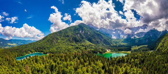 Picturesque lake Lago Fusine in Italy. Fusine lake with Mangart peak on background. Popular travel...