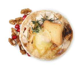 Tasty baked camembert with crouton, thyme, walnuts and pomegranate seeds isolated on white, top view