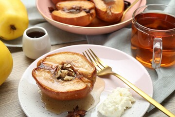 Delicious quince baked with honey and walnuts on wooden table