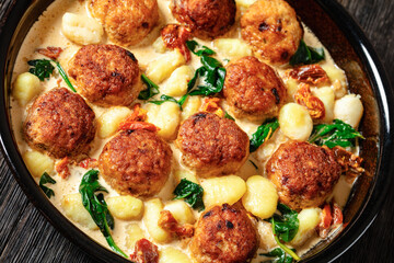tuscan chicken meatballs with gnocchi in a dish