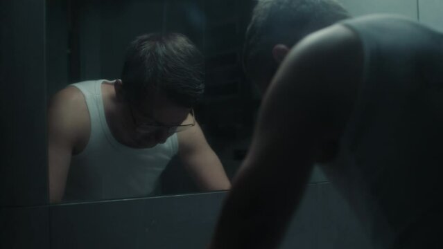 A tired middle-aged man during his morning routine