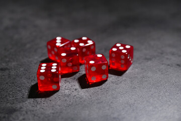 Many red game dices on grey textured table