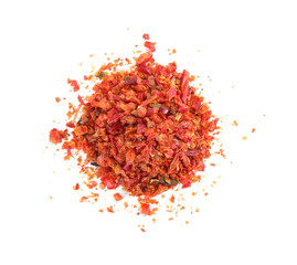 Aromatic spice. Pile of red chili pepper flakes isolated on white, top view