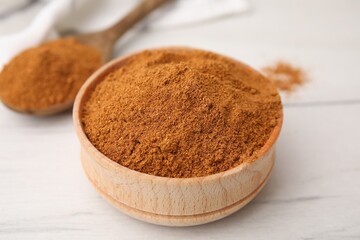 Aromatic spice. Ground red pepper in bowl on white wooden table, closeup