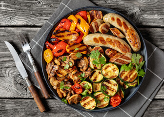grilled white sausages with veggies and mushrooms