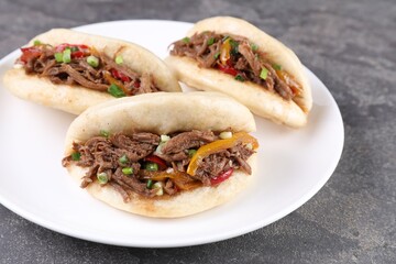 Delicious gua bao in plate on grey table