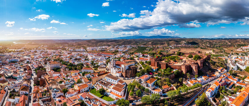 View of Silves town buildings with famous castle and cathedral, Algarve region, Portugal. Walls of medieval castle in Silves town, Algarve region, Portugal.