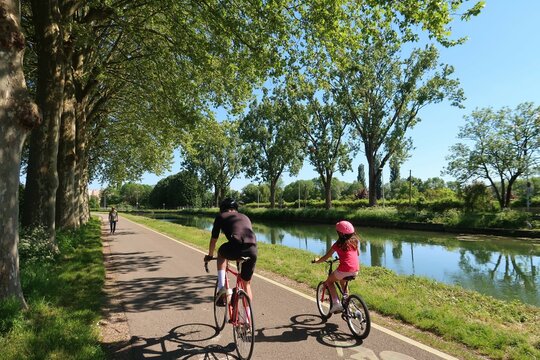 Deux cyclistes (un homme et une fillette) pratiquant le cyclotourisme sur une piste cyclable au bord du canal de Bourgogne, &agrave; Dijon, en C&ocirc;te d&rsquo;Or (France)